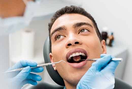 Dentist examining patient's teeth